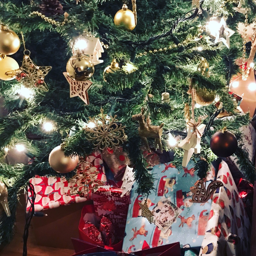 Close up photo of gifts under a Christmas tree 