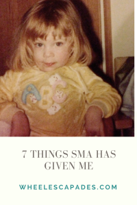 A photo of me at around 4 years old. I am sitting in a chair but am only visible from the waist up. I have shoulder length blonde hair and beam wearing a yellow jumper with ABC on. The title text ‘7 Things SMA Has Given Me’ is underneath in grey text  this is an image to pin.